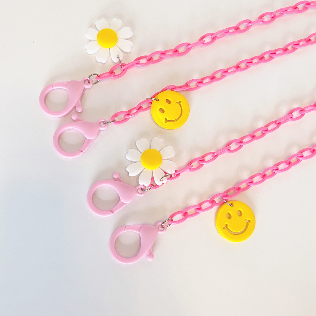 Pink Plastic Mask Holder with Daisy and Smiley Face Charms